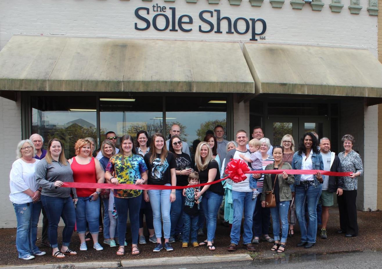 Ribbon cutting the sole shop